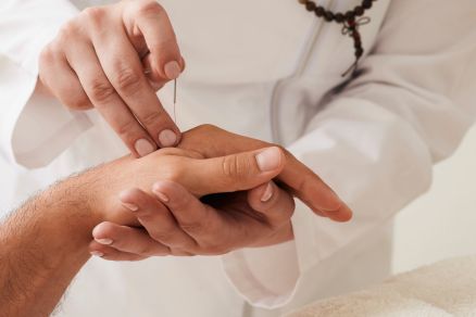 Professional doing dry needling on wrist